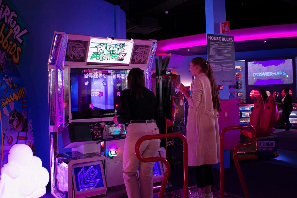 women playing arcade game