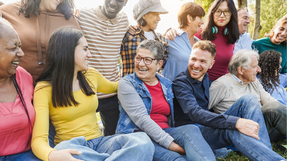 multi-age, multi-ethnic, multi-gender group outside happy telling stories embodying diversity, equity, inclusion, justice, DEI